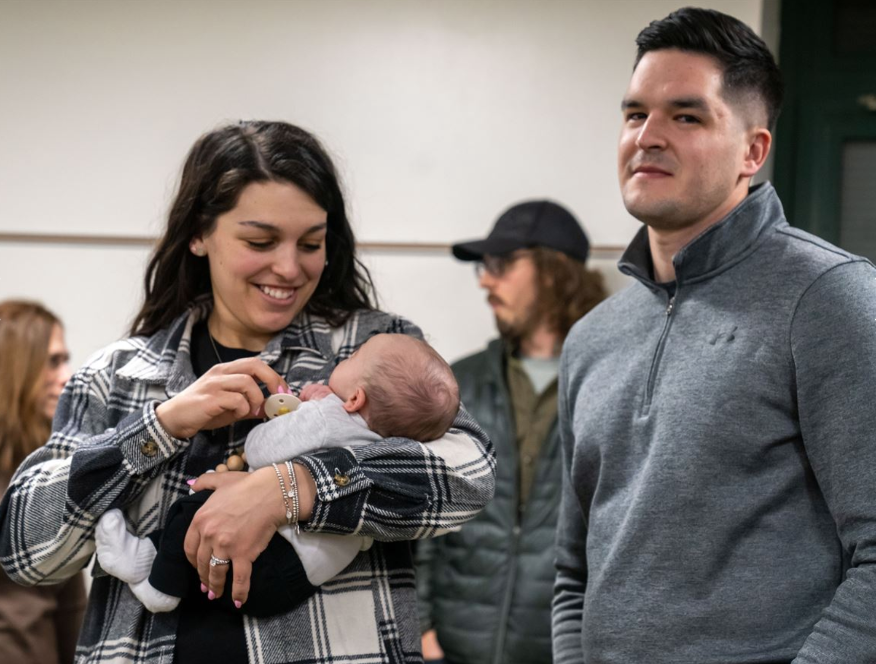 Alexis Simon, a special education teacher at Trafford Middle School, with her son, Dominic, and husband, Daniel, at a Penn-Trafford school board meeting where she thanked her colleagues for saving her after her heart stopped. (Post-Gazette)